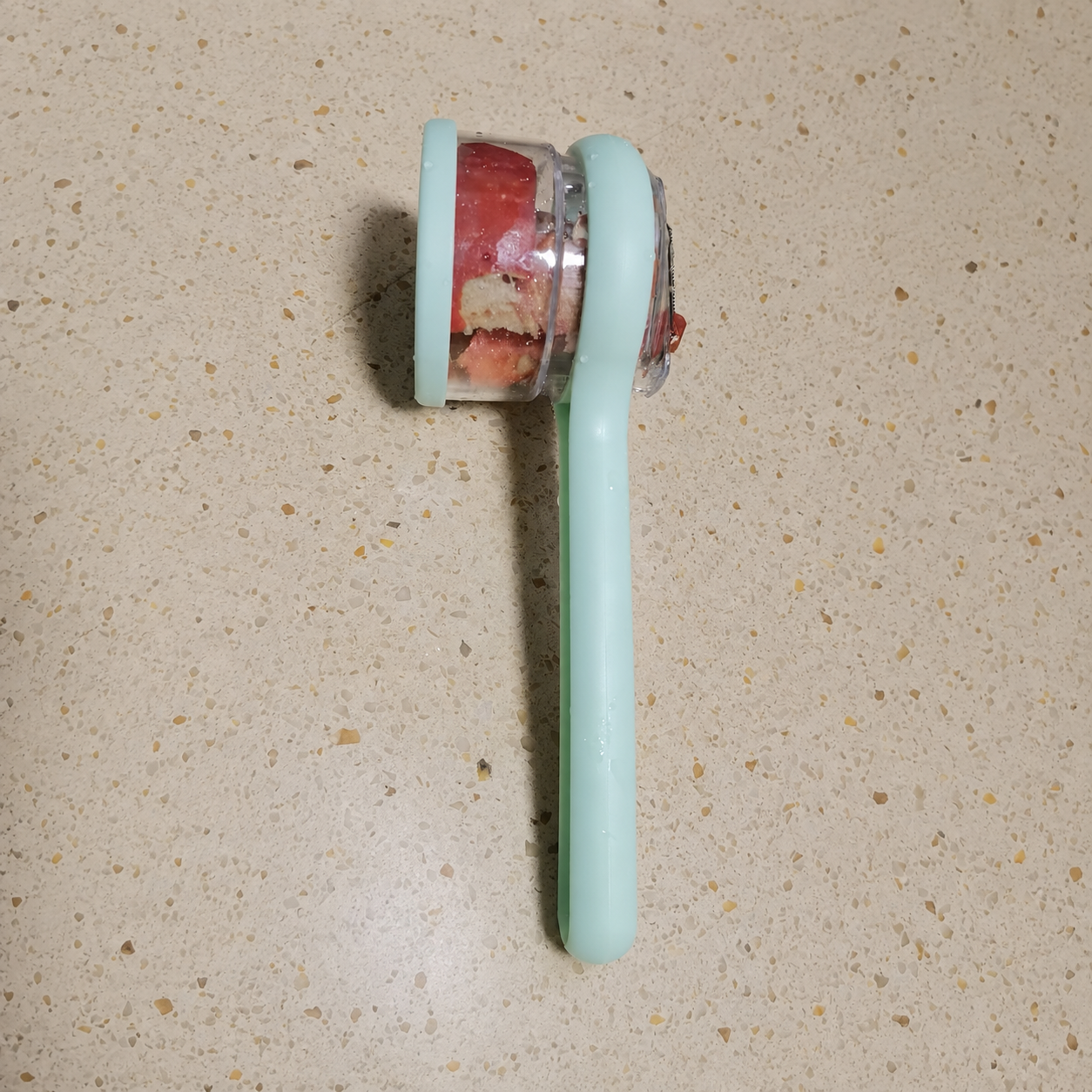 Customer using kitchen peeler with storage box on a carrot