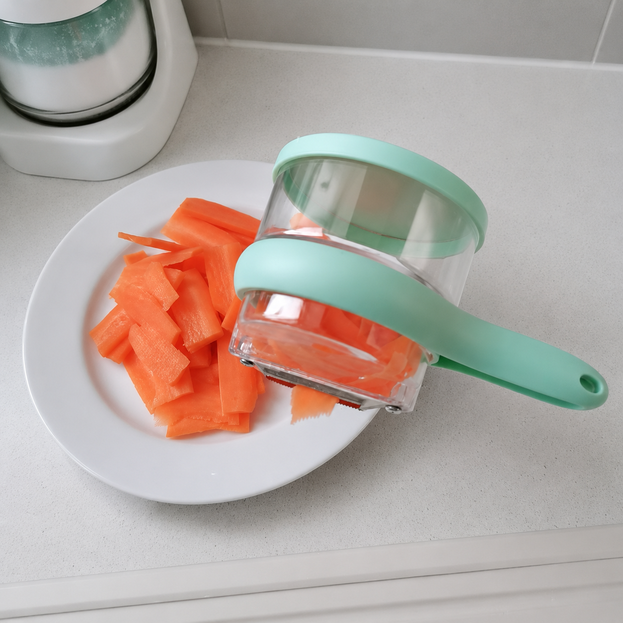 Customer rinsing kitchen peeler with storage box