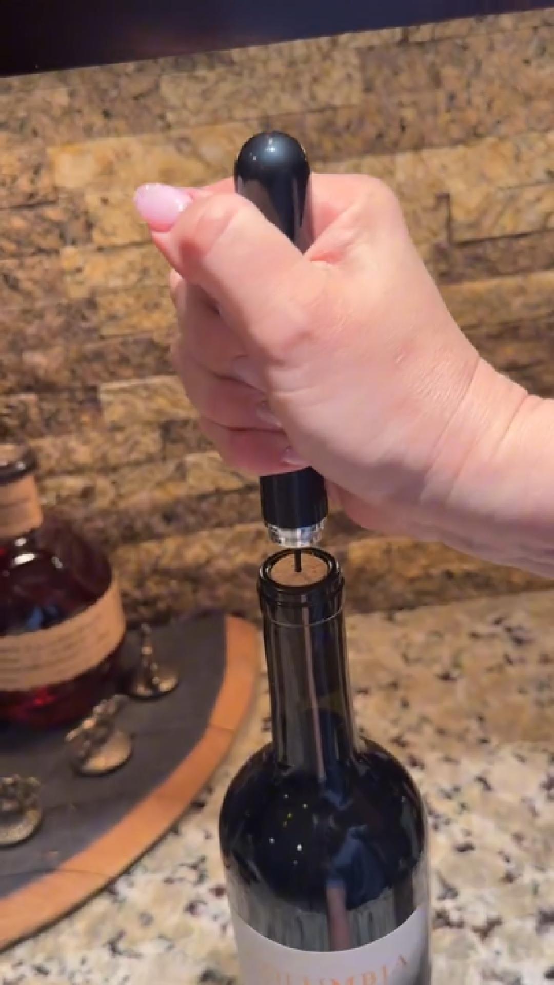 Air pressure wine opener being used on bottle