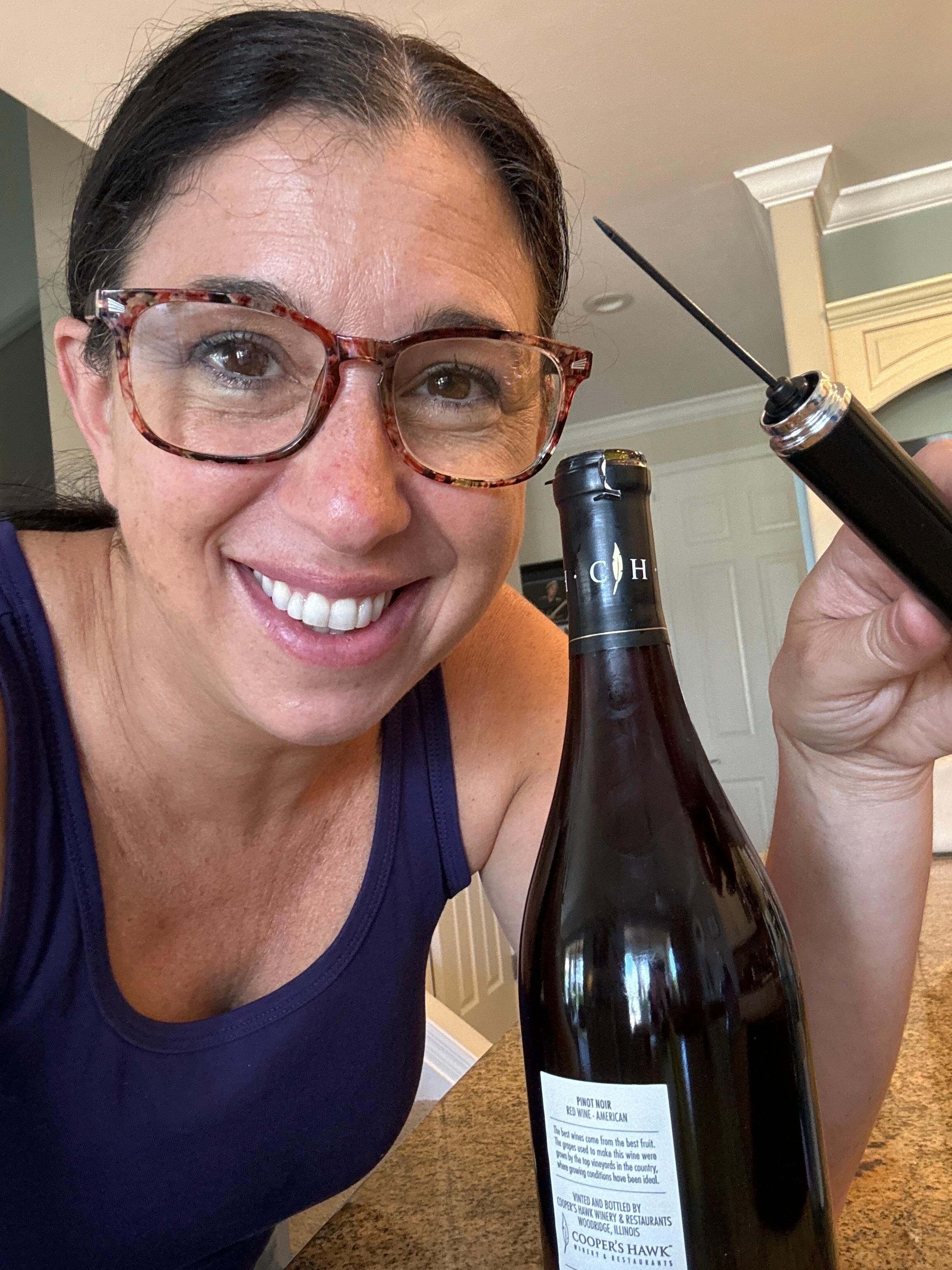 Customer smiling with air pressure wine opener and bottle